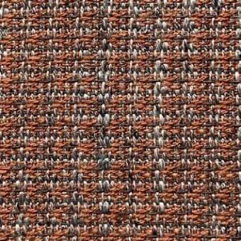 Woven fabric texture, reddish-brown with gray and off-white speckles, dense looped weave, horizontal pattern, fabric label visible.