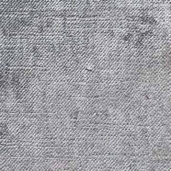 Herringbone fabric texture in light gray with tonal variations and dark flecks, displaying a dense, raised woven structure.
