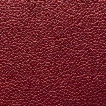Marsala leather texture with a repeating granular pattern, exhibiting a smooth sheen and consistent deep red coloration; Presotto sample.