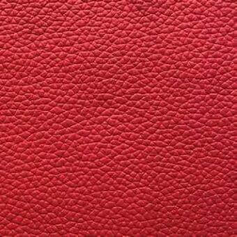 Red pebble-grain leather texture, “rosso 9l” Presotto collection, smooth consistent surface with rounded indentations, durable upholstery material.