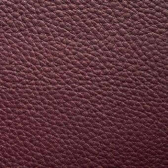 Burgundy leather texture sample displaying a granular, pebbled grain and heavy weight, with “presotto” text imprinted at the bottom edge.