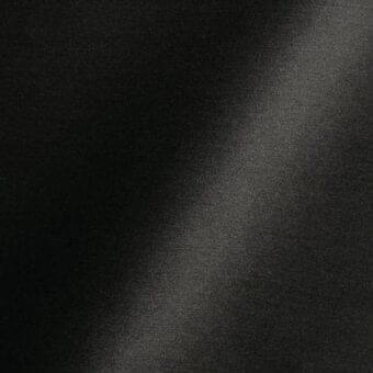 Dark matte black fabric texture with subtle vertical grain, featuring a diagonal highlight and “reflex” text label, indicating fabric collection.