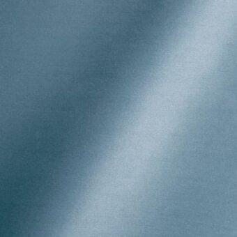 Teal woven fabric texture with diagonal light band, displaying integrated text “reflex,” “fabric,” “amsterdam,” and “danube” in a soft, granular pattern.