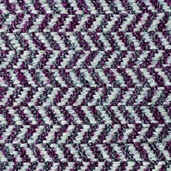 Herringbone fabric texture with white, dark gray, and blackcurrant purple threads in a dense diagonal weave, displaying a tactile, slightly irregular surface.