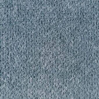 Woven fabric texture in blue-gray, looped pile construction with heathered effect, displaying “reflex” label detail and uniform density.