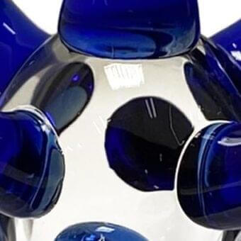 Reflex Stella Blu glass sculpture, Murano glass, featuring a central clear sphere with embedded deep blue circular accents and glossy finish.
