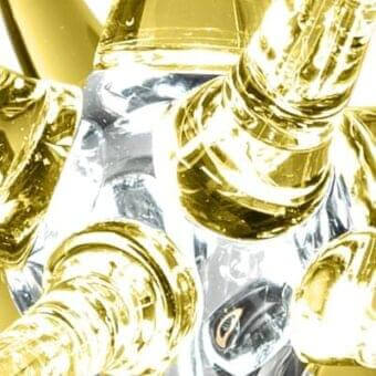 Murano glass chandelier, clear glass with gold accents, featuring elongated cylindrical elements and vertical striations.