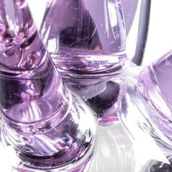 Reflex Stella Lilla Murano glass lights, translucent lavender, sculptural conical and rounded forms with glossy, striated surfaces.
