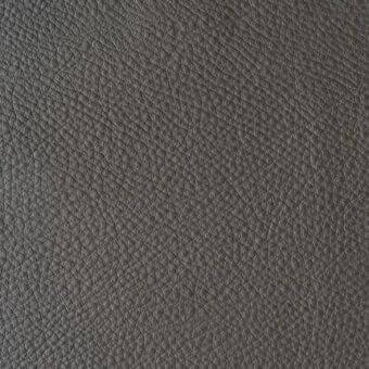 Gray leather texture sample, “reflex colorata 153 grigio quarzo,” displays a repeating embossed bump and crease pattern with matte finish.