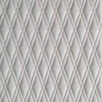 Gray quilted fabric texture features a diamond grid pattern with 45-degree stitching, creating a subtle, repeating three-dimensional upholstery design.