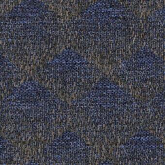 Blue-gray textured fabric sample with irregular weave, mottled with earthy brown flecks, displaying a rough, matte, nubby surface.