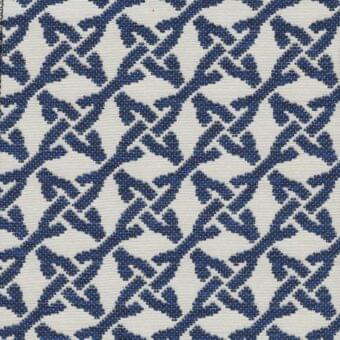 Navy blue and cream geometric textile with woven floral motifs and diagonal lines; Kristal Blu fabric from the Roberti Rattan collection.