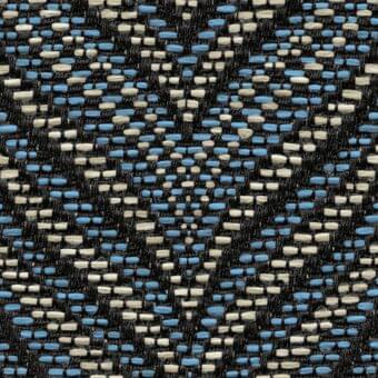 Roberti rattan fabric sample, black base with irregular blue and off-white rectangular shapes, dense nubby weave, mottled organic texture.