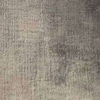Gray looped pile rug with dense, coarse texture and subtle mottled appearance; visible grid pattern from looped fibers, Kaori 28 fabric.