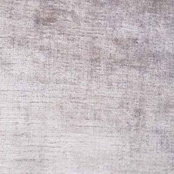 Rugiano rug, light gray, densely woven texture with subtle tonal variations and a nubby surface, displaying a muted, weathered aesthetic.