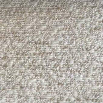 Beige textured rug with heathered and speckled appearance, dense irregular weave, and nubby surface suggesting a natural wool or blend fiber.