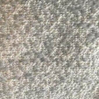 Gray and off-white textured rug with a dense, nubby weave of rounded fibers, displaying subtle tonal variations and a compact, three-dimensional surface.