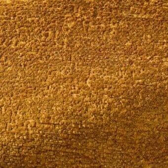 Rug, amber textured fabric, dense nubby pile with irregular surface pattern; Rugiano model 166220010 indoor fabric.