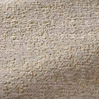 Rug, beige textured fabric, dense nubby pile with tonal variations from cream to golden hues, short granular surface, studio lighting.