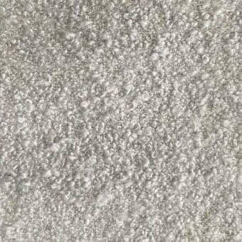 Rug, light gray, dense granular texture with irregular bumps; indoor fabric surface displaying subtle tonal variations and diffused lighting.