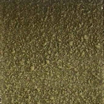 Textured rug, olive green and brown tones, spiraling pattern with raised and recessed elements creating a three-dimensional, mottled surface.