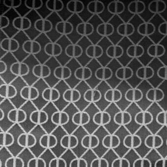 Roberti Rattan fabric sample, light gray woven textile, repeating circular diamond grid pattern with tonal contrast, indoor use.