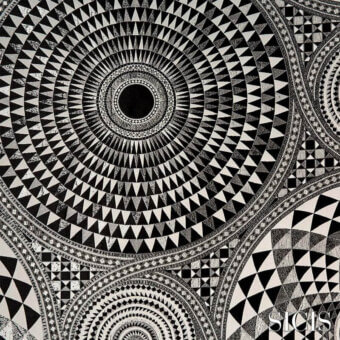 Black and white textile pattern, concentric triangles radiating from a solid black center, with checkerboard and geometric motifs visible.
