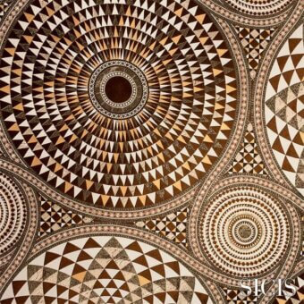 Numisma bronze fabric with concentric circles and geometric shapes in brown and beige, detailed mosaic texture, SICIS brand visible.