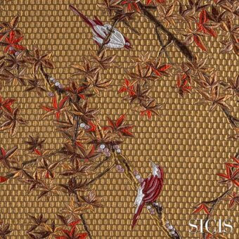 Sicis fabric sample, maple gold textile, repeating red maple leaves and purple berries with embroidered bird details on woven golden-brown threads.