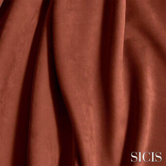 Terracotta leather sample with textured surface and cascading folds, displaying the “SICIS” logo against a dark neutral background.