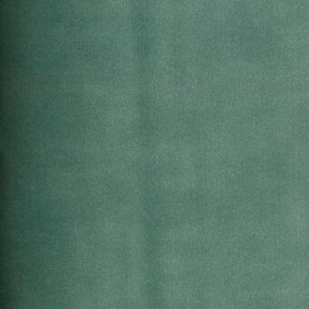 Teal velvet fabric texture with a subtle weave, displaying a matte finish and consistent color, featuring a “turri” brand label.