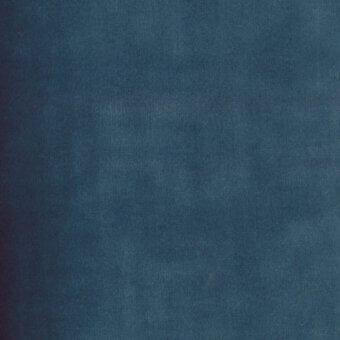 Teal fabric sample with granular texture, matte finish, and visible “turri > fabric cat. b > 740 d” label, studio lighting.