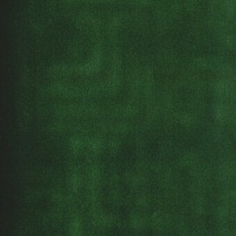 Green fabric swatch displaying a mottled texture, with tonal variations and a soft, velvety appearance suggesting a dense woven material.