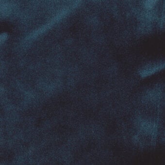 Teal fabric texture with a matte, granular surface; woven construction, partially visible label reads "turri > fabric cat. b > 744 f".
