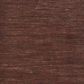 Woven fabric sample, reddish-brown and off-white, dense texture with visible weave and subtle irregular pattern, brand label visible.