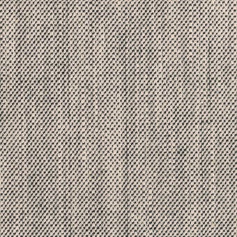 Woven textile sample, dark gray and beige geometric pattern, dense nubby texture, light beige background, vertical line detail, matte finish.