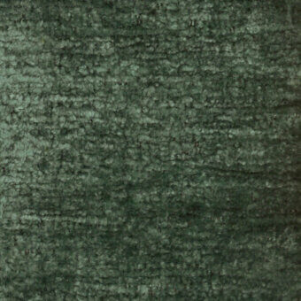 Dark green textured fabric sample displaying a mottled, granular surface with looped pile and horizontal striations, labeled “turri fabric cat. b 778 d.”