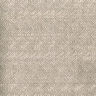 Herringbone fabric sample in light beige and taupe tones features a dense weave, matte finish, and diagonal pattern with a visible brand label.