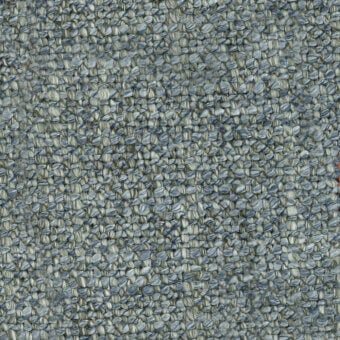 Heathered fabric sample with muted gray and blue tones, displaying a dense, irregular weave and pebble-like texture; tag reads "turri > fabric cat. t > 770 e".