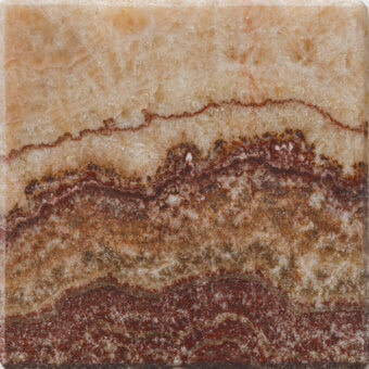 Tile sample, beige and tan onyx texture, with reddish-brown umber bands, undulating pattern, grainy matte surface, crystalline inclusion.