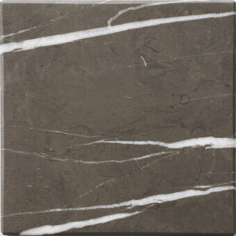 Dark grey marble tile sample with diagonal white veining, mottled texture, and matte finish, displaying natural stone variations.