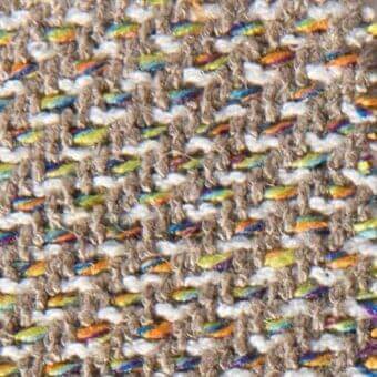 Gray tweed fabric texture with teal, orange, yellow, and blue threads; dense irregular weave, matte finish, sample labeled “adele 15059”.