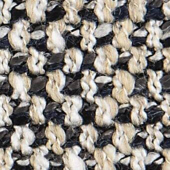 Woven fabric texture, off-white and black, irregular looped pattern with grid structure; verzelloni belfort 18012 fabric sample closeup.