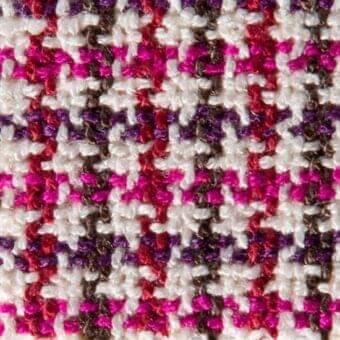 Glen plaid fabric texture, off-white with pink, purple, and brown yarns, featuring a repeating check weave and matte finish.