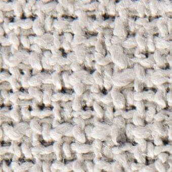 Beige woven fabric texture with looped yarns, heathered tonal variations, and a nubby surface; verzelloni janis 15026 label visible.
