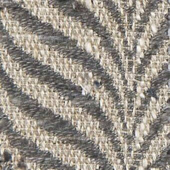 Herringbone woven fabric with muted gray and creamy beige tones, displaying a dense, slightly irregular chevron texture and matte finish.