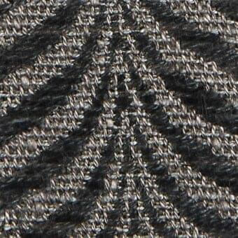 Herringbone fabric texture in dark gray and silver tones, displaying a dense, diagonal rib weave with a subtle metallic sheen and nubby threads.