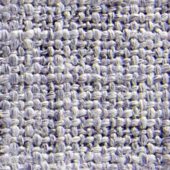 Heathered gray-lavender woven fabric texture, dense irregular weave with nubby surface, interspersed with sporadic yellow threads, Norah 15025.