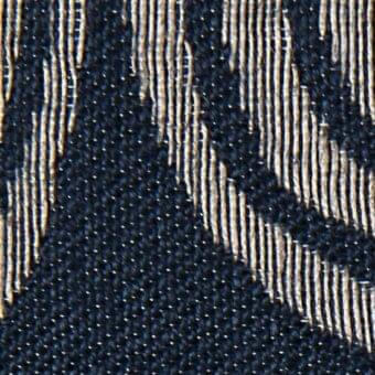 Navy blue fabric texture with raised, irregular beige strands creating a fragmented linear pattern and a dense, matte weave.