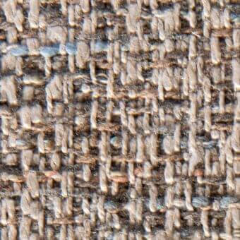 Heathered tweed fabric texture with gray, beige, and brown yarns displaying a nubby, irregular weave and subtle white flecks.